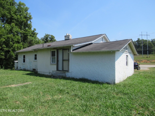 10827 Rutledge Pike, Blaine, TN 37709 - view of property exterior featuring a lawn and stucco siding