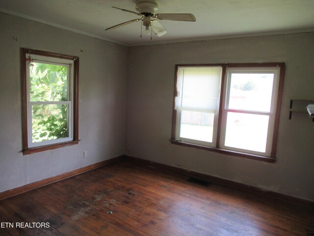 empty room featuring ceiling fan, ornamental molding, and dark hardwood / wood-style flooring