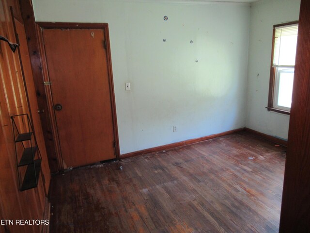 empty room with dark hardwood / wood-style floors