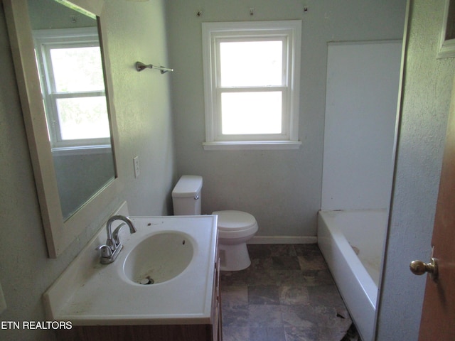 10827 Rutledge Pike, Blaine, TN 37709 - bathroom with baseboards, toilet, vanity, and a tub to relax in