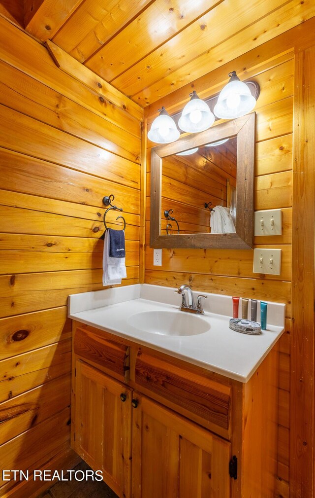 bathroom featuring wooden ceiling, vanity, and wood walls