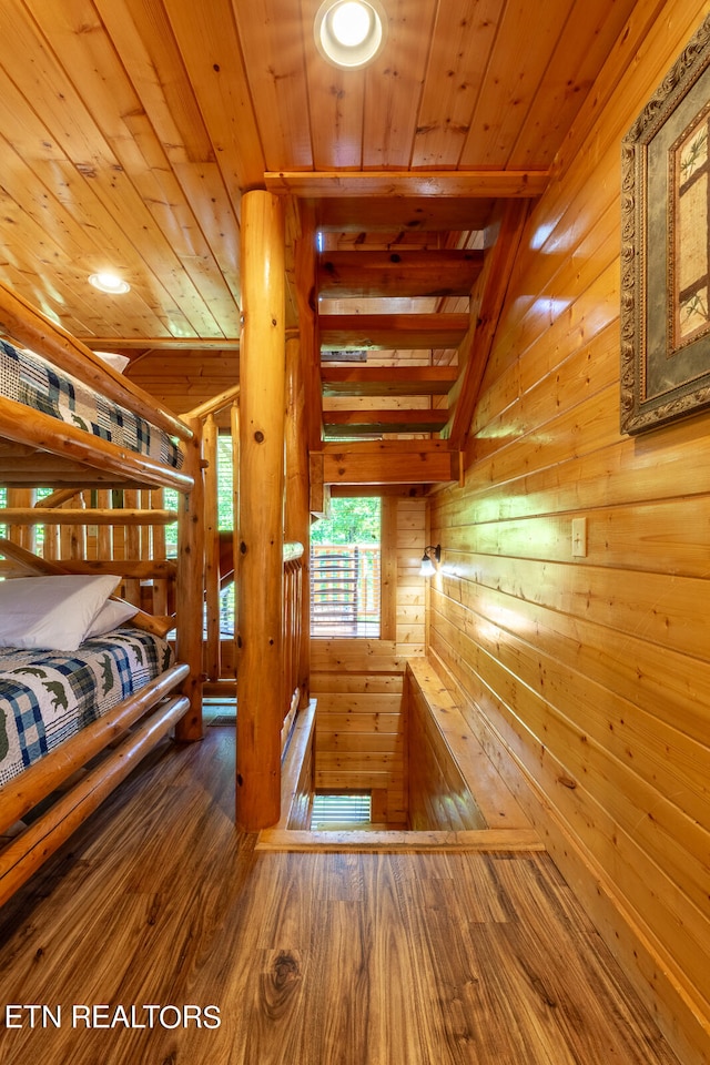 bedroom featuring hardwood / wood-style floors, wood ceiling, and wood walls