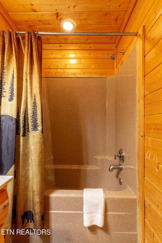 bathroom with shower / bath combo with shower curtain, wooden walls, and wooden ceiling