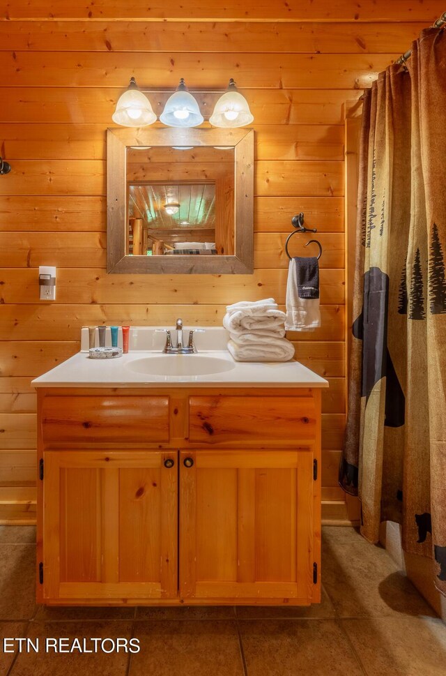 bathroom with vanity, curtained shower, and tile patterned flooring