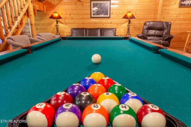 game room featuring pool table and wooden walls