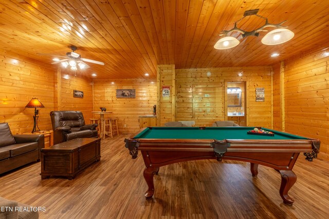 recreation room featuring pool table, wooden walls, light hardwood / wood-style floors, and ceiling fan