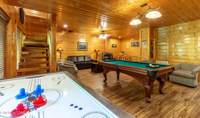 rec room with ceiling fan, wood-type flooring, wood walls, and pool table