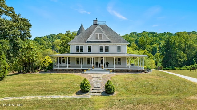 farmhouse featuring a porch and a front lawn