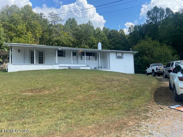 single story home featuring a front lawn