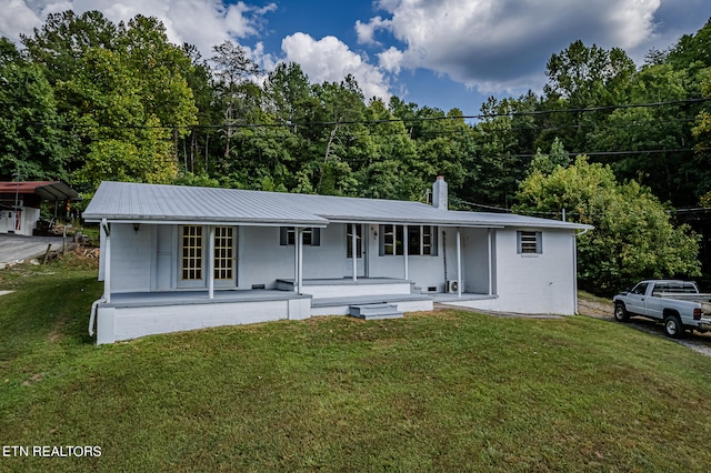 single story home with covered porch and a front yard