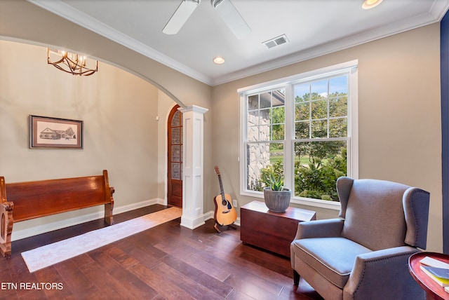 living area with dark wood-type flooring, ceiling fan, and ornamental molding