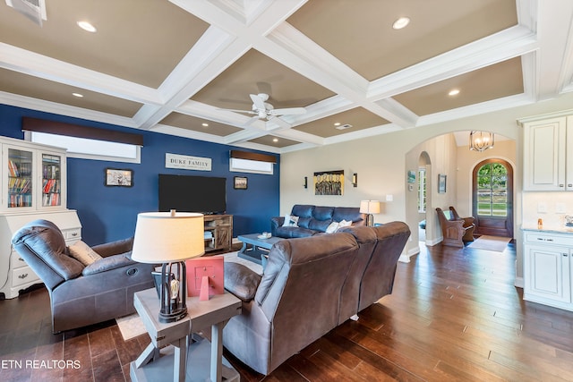 living room with coffered ceiling, beamed ceiling, ceiling fan with notable chandelier, dark wood-type flooring, and ornamental molding