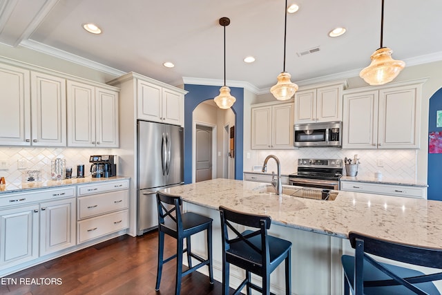 kitchen with crown molding, decorative light fixtures, appliances with stainless steel finishes, and dark hardwood / wood-style flooring