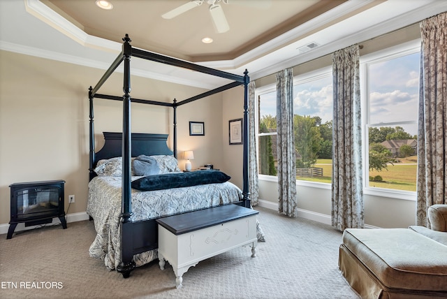 bedroom with crown molding, a raised ceiling, light carpet, and ceiling fan