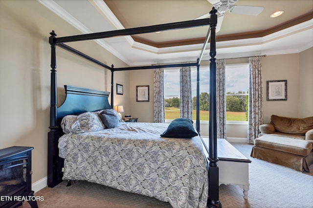 bedroom with crown molding, a raised ceiling, ceiling fan, and carpet floors