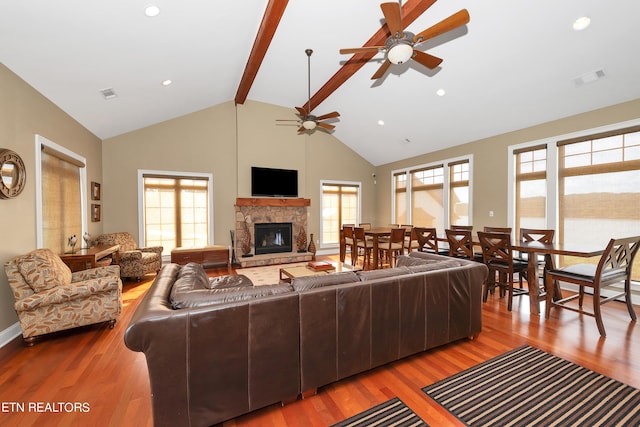 living room featuring a healthy amount of sunlight, ceiling fan, wood-type flooring, and a fireplace