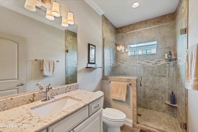 bathroom featuring a shower with shower door, toilet, ornamental molding, and vanity