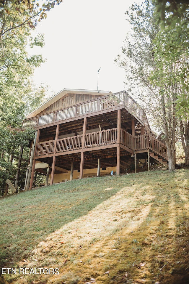 exterior space with a deck and a front lawn