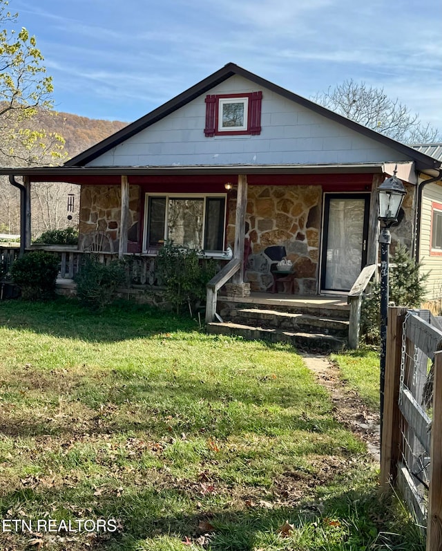 view of front of property with covered porch and a front yard