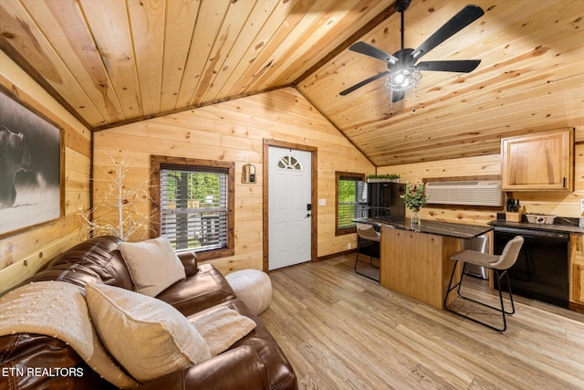 living room featuring wood ceiling, vaulted ceiling, light wood-type flooring, ceiling fan, and wooden walls