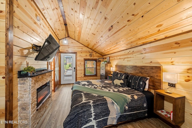 bedroom with lofted ceiling with beams, dark wood-type flooring, a fireplace, wood walls, and wooden ceiling