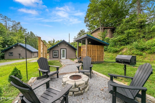 view of patio with a fire pit and an outdoor structure