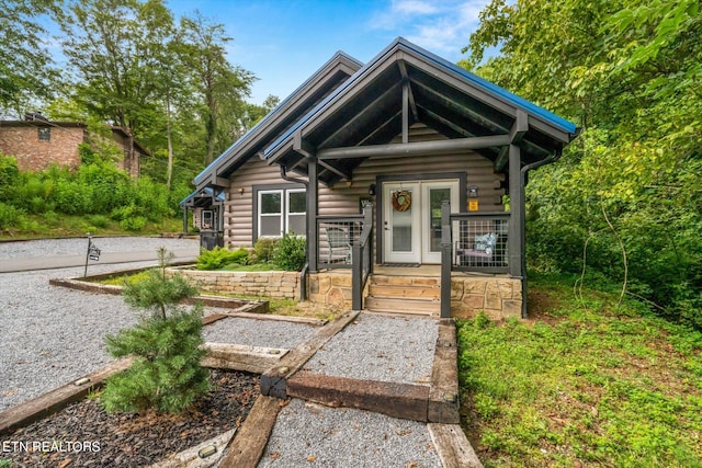 log cabin featuring covered porch