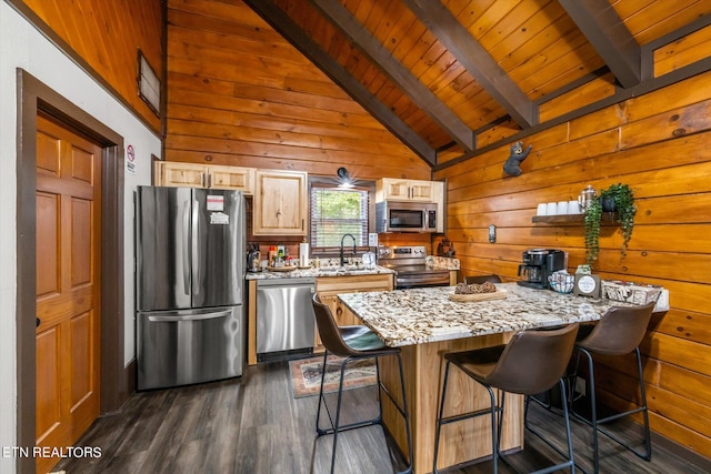 kitchen with a kitchen breakfast bar, wood walls, dark hardwood / wood-style flooring, and stainless steel appliances