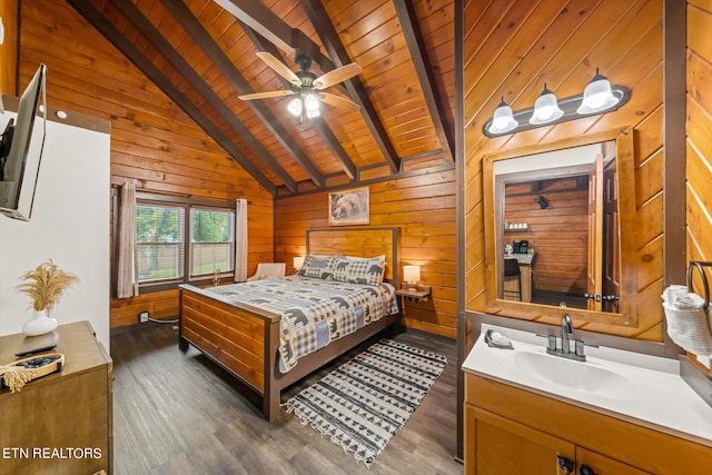 bedroom featuring wood walls, ceiling fan, dark hardwood / wood-style floors, and sink