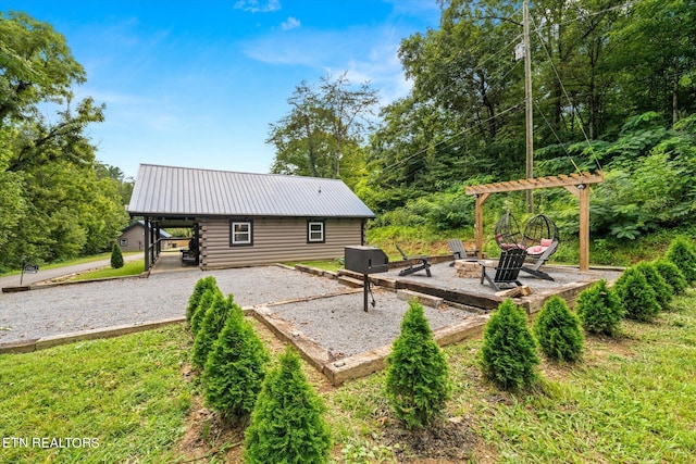 back of house featuring a patio and an outdoor fire pit