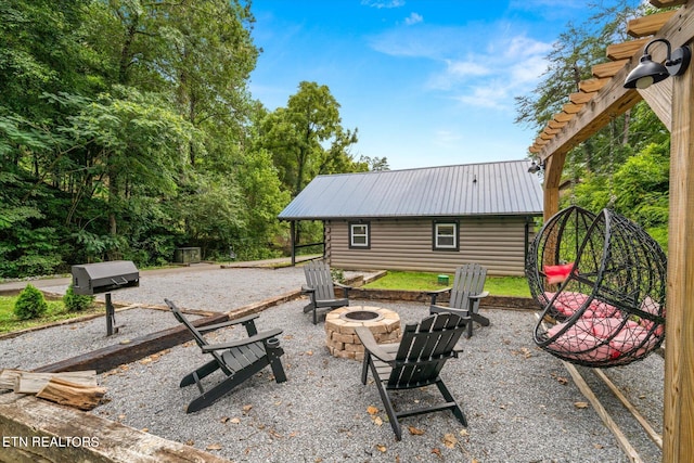 view of patio / terrace featuring an outdoor fire pit