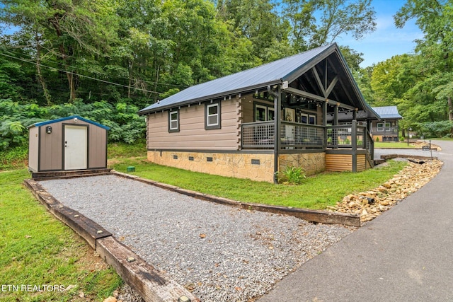 view of home's exterior with a storage shed and a lawn