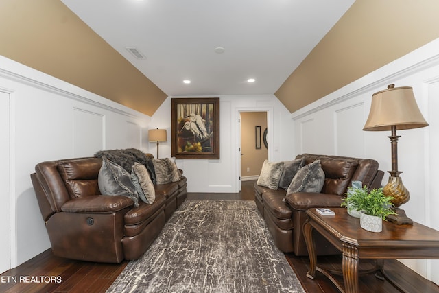 living room featuring lofted ceiling and dark wood-type flooring