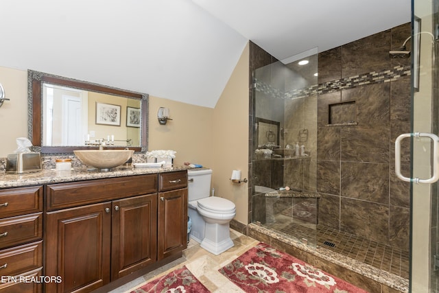 bathroom with vanity, vaulted ceiling, tile patterned flooring, toilet, and a shower with shower door