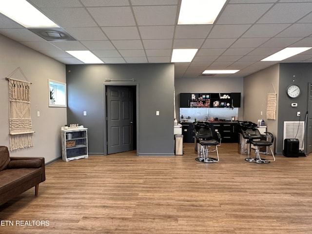 interior space with hardwood / wood-style flooring and a drop ceiling