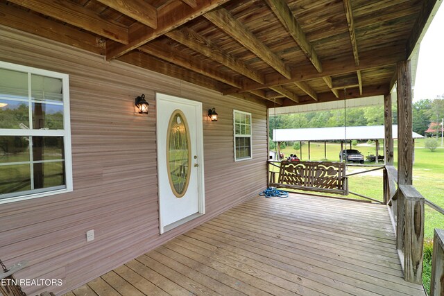 wooden terrace with a yard