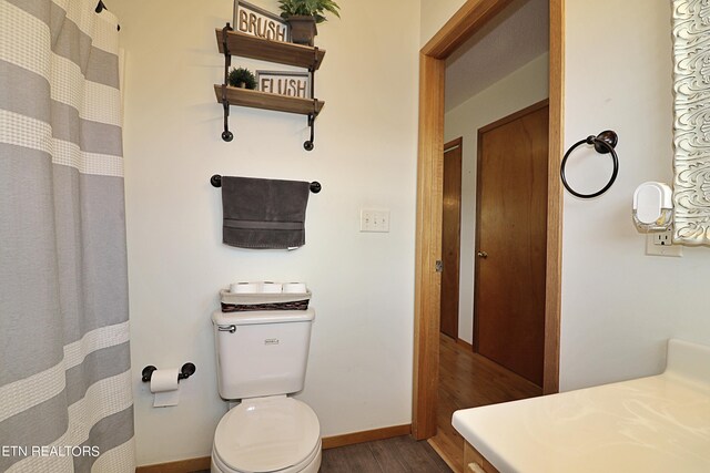 bathroom featuring toilet and hardwood / wood-style flooring