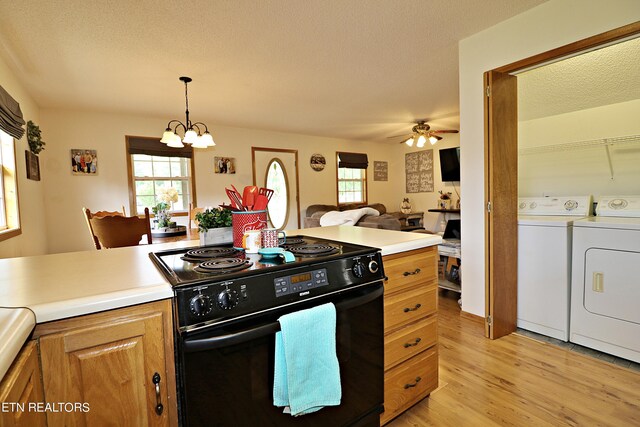 kitchen featuring ceiling fan with notable chandelier, a textured ceiling, light hardwood / wood-style flooring, washer and dryer, and electric range