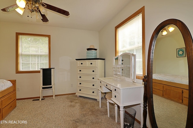 bedroom featuring baseboards, ceiling fan, multiple windows, and light carpet