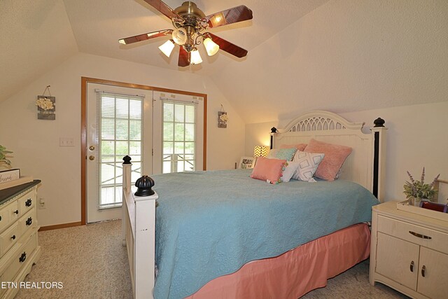 carpeted bedroom with lofted ceiling, ceiling fan, and a textured ceiling