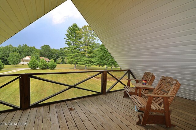 wooden terrace with a yard