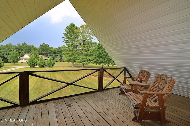 wooden terrace featuring a lawn