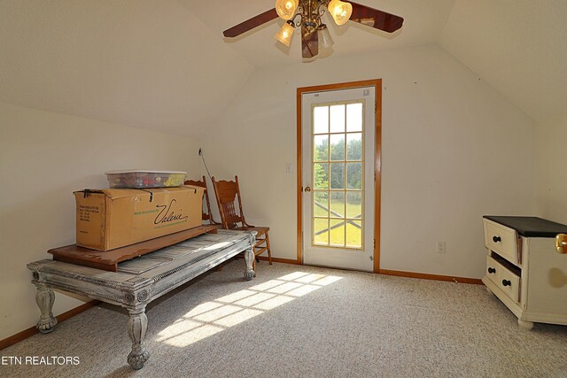 interior space featuring light colored carpet, lofted ceiling, and ceiling fan