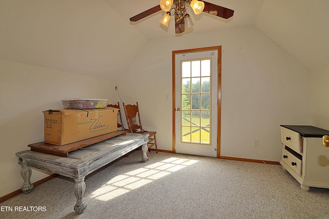 unfurnished room featuring carpet floors, baseboards, lofted ceiling, and ceiling fan