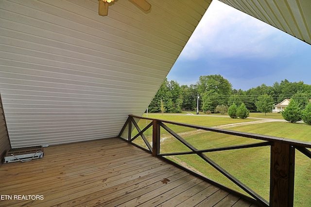 deck featuring a lawn and a ceiling fan