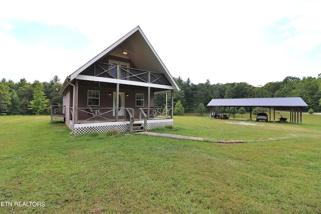 view of front of property with covered porch, a balcony, a front yard, and a carport