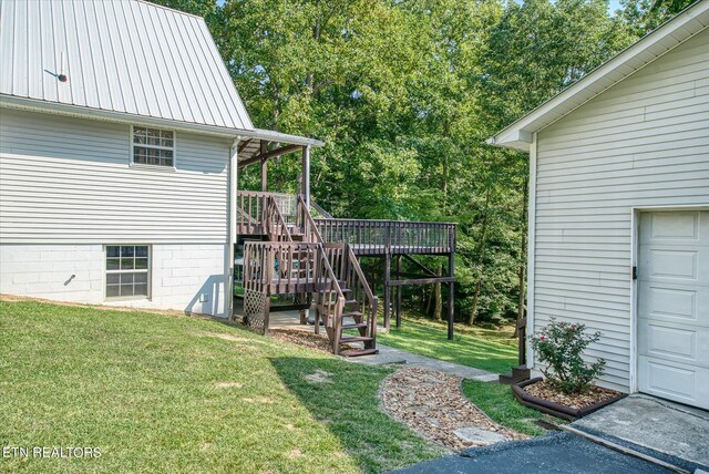 view of yard featuring a garage and a deck