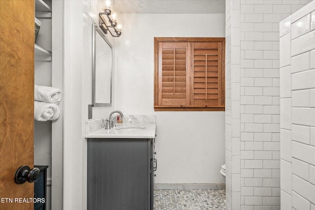 bathroom featuring tile patterned floors, toilet, and vanity