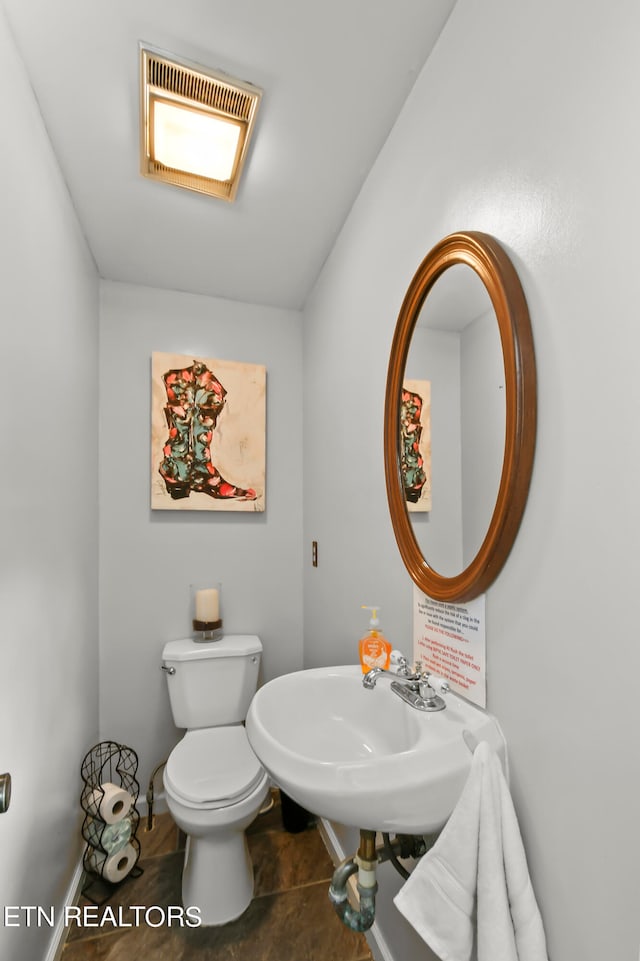 bathroom featuring tile patterned flooring, toilet, and sink