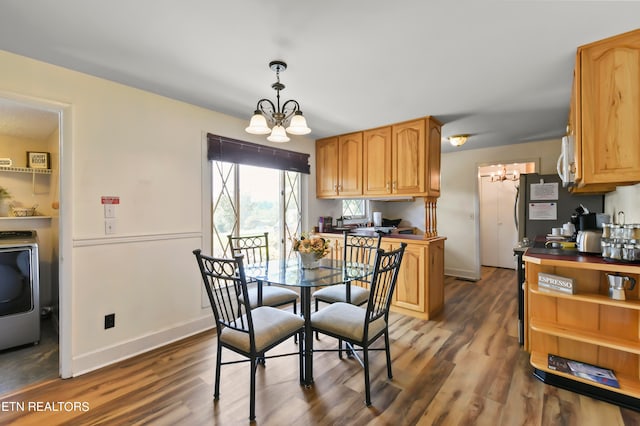 dining area featuring dark hardwood / wood-style floors and an inviting chandelier